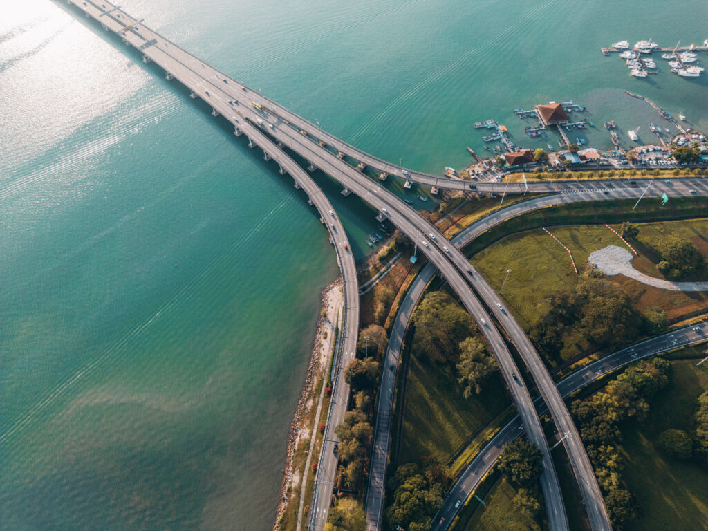 Aerial view of a coastal roadway interchange with bridges over water.