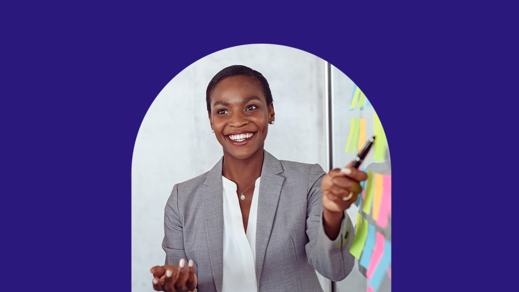 Professional woman presenting with sticky notes in a business setting.