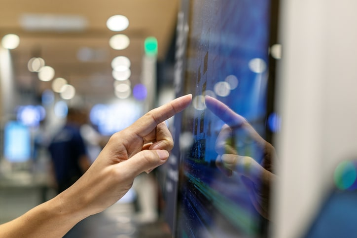 woman using bill payment kiosk in a secure location because of Euna Payments
