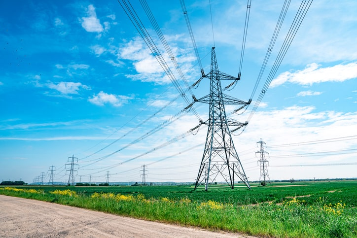 Utility towers in fields